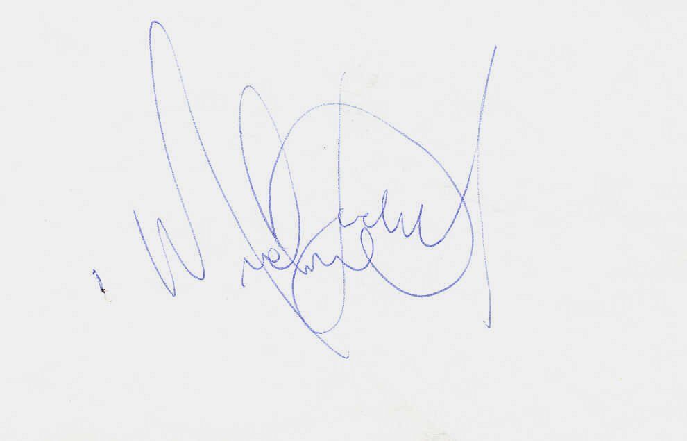 Michael Jackson signing an autograph on a piece of paper held in an open hand